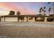 Single story home with desert landscaping and palm trees in front yard at 302 E Coral Gables Dr, Phoenix, AZ 85022