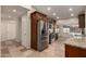 Well-lit kitchen featuring stainless steel appliances, dark wood cabinets, and granite countertops at 302 E Coral Gables Dr, Phoenix, AZ 85022