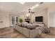 Spacious living room featuring a ceiling fan, recessed lighting, and large sectional sofa at 302 E Coral Gables Dr, Phoenix, AZ 85022