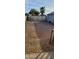 Large backyard with gravel and a metal gate at 3133 W Polk St, Phoenix, AZ 85009