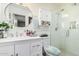 Clean bathroom with white vanity, updated fixtures, and glass shower at 410 N 56Th Pl, Mesa, AZ 85205