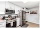 Modern kitchen with stainless steel appliances and white cabinetry at 410 N 56Th Pl, Mesa, AZ 85205