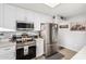 Modern kitchen features stainless steel appliances and white cabinetry at 410 N 56Th Pl, Mesa, AZ 85205