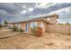 Tan two-story building with gray door, red flowers, and a walkway at 4242 N 69Th Dr # 1303, Phoenix, AZ 85033