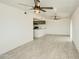 Open living room, featuring tile floors and a view of the kitchen at 4242 N 69Th Dr # 1303, Phoenix, AZ 85033