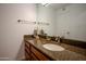 Bathroom vanity with granite countertop, sink, framed mirror, and neutral fixtures at 4354 N 82Nd St # 137, Scottsdale, AZ 85251