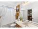 Bright bathroom with a framed mirror over the sink and tub and shower combo with white shower curtain at 476 E Atlantic Dr, Casa Grande, AZ 85122