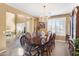 Elegant dining room featuring a chandelier, hardwood floors, and a formal wood table with seating for eight at 476 E Atlantic Dr, Casa Grande, AZ 85122