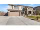 Exterior elevation of a beautiful two-story home with a brick-accented facade and manicured lawn at 476 E Atlantic Dr, Casa Grande, AZ 85122