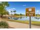 Villago Lake community signage and views of landscaped walking path and scenic lake at 476 E Atlantic Dr, Casa Grande, AZ 85122