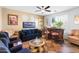 Cozy living room featuring a wet bar, ceiling fan, and comfortable seating for relaxing and entertaining guests at 476 E Atlantic Dr, Casa Grande, AZ 85122