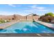 Backyard pool with surrounding patio, decorative statues and privacy wall at 476 E Atlantic Dr, Casa Grande, AZ 85122