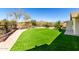 Backyard features artificial turf, desert landscaping, a pergola, and a walkway at 50031 N 27Th Ave, New River, AZ 85087