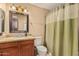 Bathroom features a granite countertop vanity, a mirror, and a shower with a curtain at 50031 N 27Th Ave, New River, AZ 85087