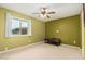 Bedroom with a window providing natural light, carpeted floors, and a ceiling fan at 50031 N 27Th Ave, New River, AZ 85087