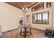 Dining room with wood-paneled ceiling, elegant chandelier, and view of the outdoor scenery at 50031 N 27Th Ave, New River, AZ 85087