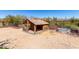 Outdoor dog run with gravel ground, a shelter, and a metal watering trough at 50031 N 27Th Ave, New River, AZ 85087