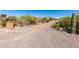 Long gravel driveway leading to the house, surrounded by desert vegetation and a mailbox at 50031 N 27Th Ave, New River, AZ 85087