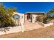 Welcoming entrance with a unique wagon wheel window, multiple stairs and an arched gate at 50031 N 27Th Ave, New River, AZ 85087