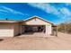 A spacious garage exterior featuring a wide door and desert landscaping at 50031 N 27Th Ave, New River, AZ 85087