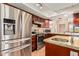 Bright kitchen with stainless steel appliances, dark wood cabinetry, stone countertops, and modern sink at 50031 N 27Th Ave, New River, AZ 85087