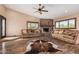 Bright living room with a stone fireplace, hardwood floors and comfortable seating at 50031 N 27Th Ave, New River, AZ 85087