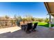Scenic patio featuring a dining set, grill, and views of the desert landscaping and blue sky at 50031 N 27Th Ave, New River, AZ 85087