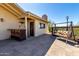 Covered back patio with tile flooring, an outdoor bar, a swing, and desert views at 50031 N 27Th Ave, New River, AZ 85087