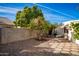 Backyard with gravel, two orange trees, and a block wall at 5807 E Leonora St, Mesa, AZ 85215