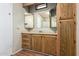 Bathroom with wood cabinets and a mirrored medicine cabinet at 5807 E Leonora St, Mesa, AZ 85215