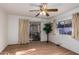 Bedroom with wood flooring, ceiling fan, and sliding door to patio at 5807 E Leonora St, Mesa, AZ 85215