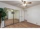 Spacious bedroom with mirrored closet doors and wood-look floors at 5807 E Leonora St, Mesa, AZ 85215