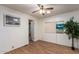 Bright bedroom featuring wood-look flooring and a ceiling fan at 5807 E Leonora St, Mesa, AZ 85215