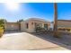 Tan single-wide manufactured home with carport and landscaped yard at 5807 E Leonora St, Mesa, AZ 85215