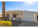 Front view of a tan manufactured home with a carport at 5807 E Leonora St, Mesa, AZ 85215