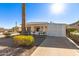 Tan manufactured home with a white lattice-covered carport at 5807 E Leonora St, Mesa, AZ 85215