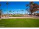 Golf course with palm trees and residential homes at 5807 E Leonora St, Mesa, AZ 85215