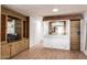 Built-in home bar with wood shelving and mirror at 5807 E Leonora St, Mesa, AZ 85215