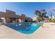 Community pool with lounge chairs, desert landscaping, and shade cover at 7444 N 43Rd Ln, Glendale, AZ 85301