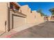 View of the exterior showcasing a home with an attached garage, in a community with desert landscaping at 7444 N 43Rd Ln, Glendale, AZ 85301