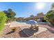 Community pool featuring a striped umbrella with table, palm trees, and a well-maintained deck at 7444 N 43Rd Ln, Glendale, AZ 85301