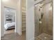 Elegant bathroom featuring a glass-enclosed shower with stone tile and a view into a spacious bedroom at 7705 E Doubletree Ranch Rd # 56, Scottsdale, AZ 85258