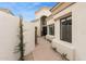 Pathway leading to a front door with an arched transom window on a stucco home with desert landscaping at 7705 E Doubletree Ranch Rd # 56, Scottsdale, AZ 85258