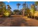 The gate entrance to the community at night, with manicured shrubs and palm trees at 7705 E Doubletree Ranch Rd # 56, Scottsdale, AZ 85258