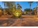 The gate entrance to the community at night, with manicured landscaping and accent lighting at 7705 E Doubletree Ranch Rd # 56, Scottsdale, AZ 85258