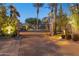 Illuminated security gate, with prominent palm trees and landscaping at 7705 E Doubletree Ranch Rd # 56, Scottsdale, AZ 85258