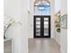 Bright foyer features a tall, arched window above a frosted glass door, and decor shelves at 7705 E Doubletree Ranch Rd # 56, Scottsdale, AZ 85258