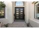 Close up of the main entrance featuring a modern frosted glass door and light colored stucco at 7705 E Doubletree Ranch Rd # 56, Scottsdale, AZ 85258