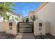 View of the front yard featuring a modern gate with stucco pillars with modern address lighting at 7705 E Doubletree Ranch Rd # 56, Scottsdale, AZ 85258