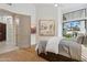 Main bedroom featuring light wood floors, stylish decor and a door to a private patio at 7705 E Doubletree Ranch Rd # 56, Scottsdale, AZ 85258